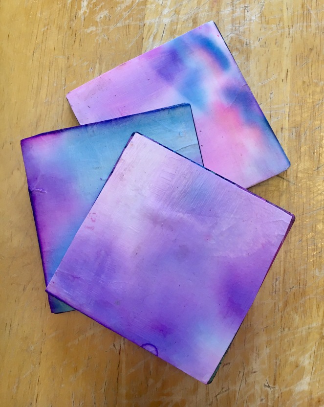 DIY coasters made out of kid paintings and prints